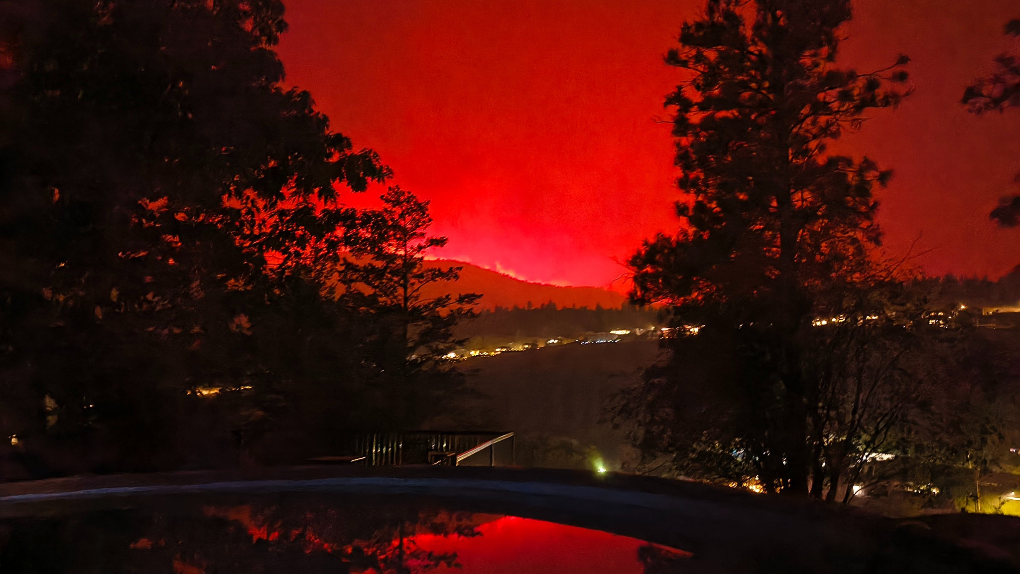 Night view of the wildfire turning the sky red over Summerland